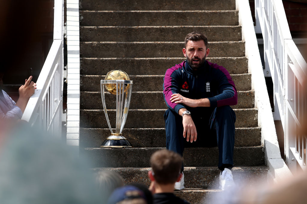 Liam Plunkett sits next to World Cup Trophy