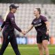 Alice Capsey (right) shares a laugh with fellow spinner Sophie Ecclestone during an England nets session