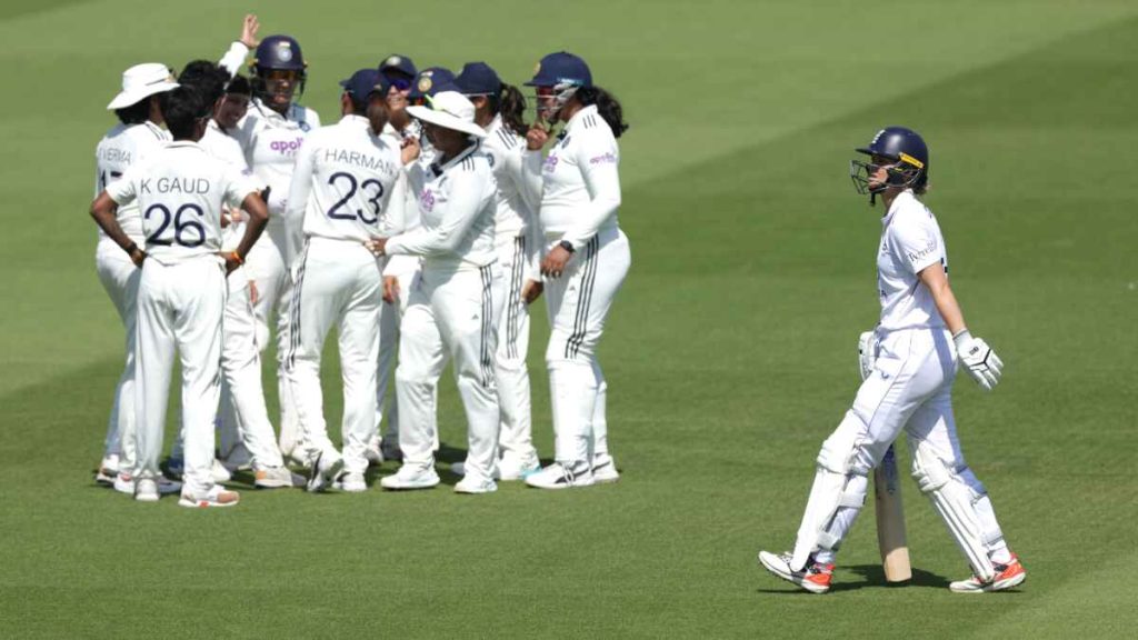 England’s Amy Jones, right, leaves the pitch as India players celebrate her wicket