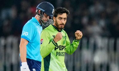Arafat Minhas, right, celebrates after taking the wicket of Jamie Overton.