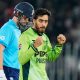 Arafat Minhas, right, celebrates after taking the wicket of Jamie Overton.
