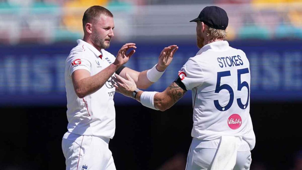 Gus Atkinson (left) celebrates a wicket with Ben Stokes in Brisbane.