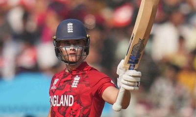 Jacob Bethell raises his bat after reaching his half-century against Nepal