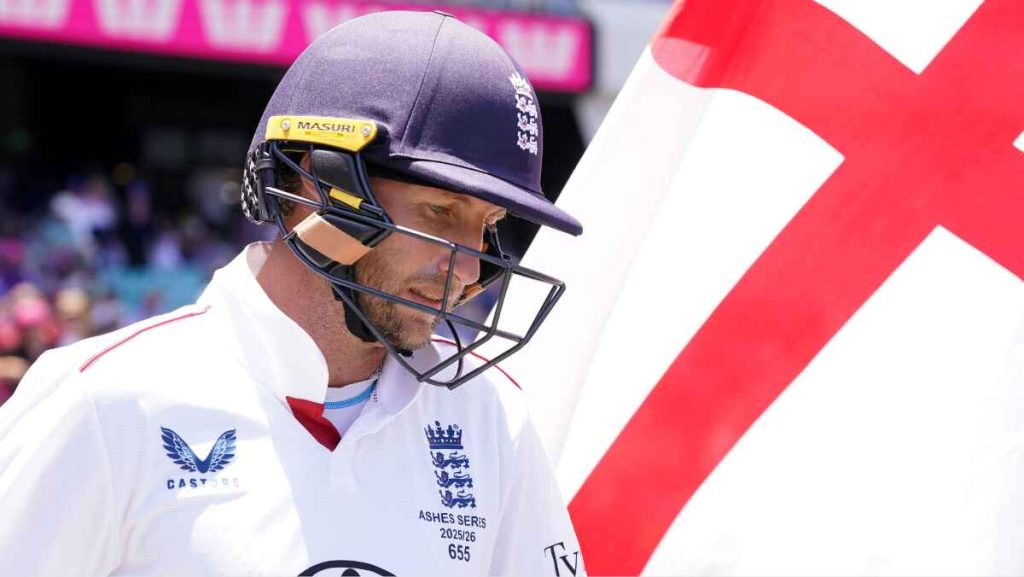 Joe Root walks out to bat next to an English flag.