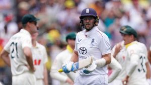 England's Joe Root (centre) walks off after being dismissed by Australia’s Mitchell Starc