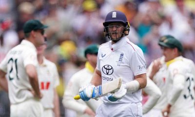 England's Joe Root (centre) walks off after being dismissed by Australia’s Mitchell Starc