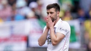 England's Mark Wood looks frustrated after being hit for a six