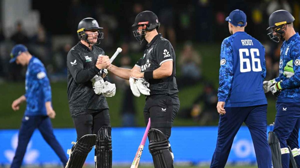 Nathan Smith, left, and Daryl Mitchell shake hands after securing victory