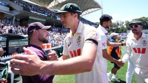 Australia’s Pat Cummins shakes hands with England head coach Brendon McCullum