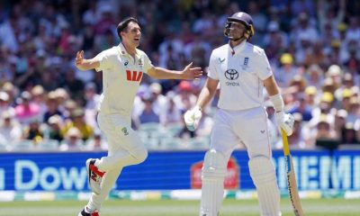 Australia’s Pat Cummins, left, celebrates taking the wicket of England's Joe Root