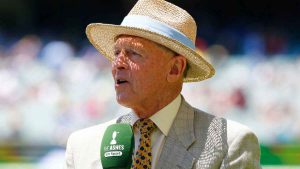 Former England captain Sir Geoffrey Boycott speaking into a microphone.