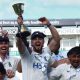 Warwickshire’s captain Ed Barnard lifts the County Championship trophy