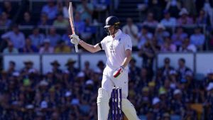 England’s Zak Crawley raises his bat to celebrate reaching his half century on day one of the second Ashes Test in Brisbane
